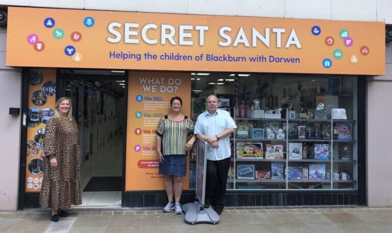 The Mall Blackburn is kicking off its search for an official charity to support in 2022 - Loraine Jones with Haren and Phil Boulding at the Secret Santa store scaled 1 scaled