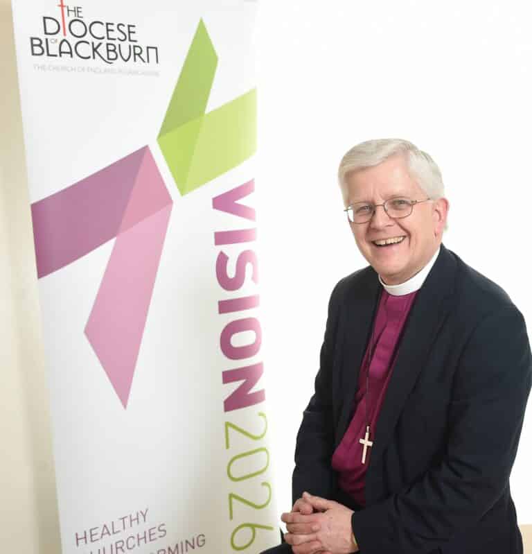 Bishop of Blackburn announces retirement - Rt Rev. Julian Henderson with a Vision 2026 banner scaled