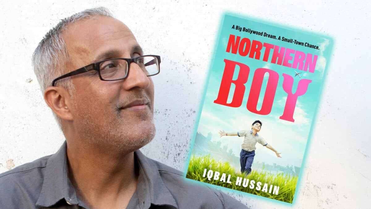 Blackburn-born author Iqbal Hussain holding his novel Northern Boy ahead of his event at Blackburn Central Library