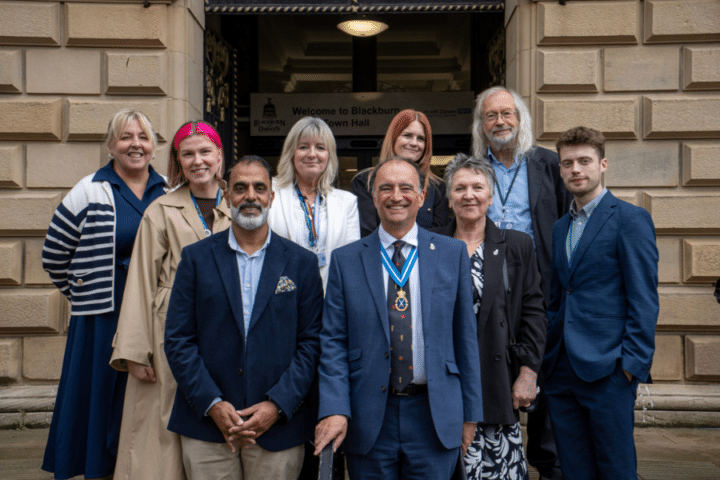 A group of people standing outside Blackburn Town Hall