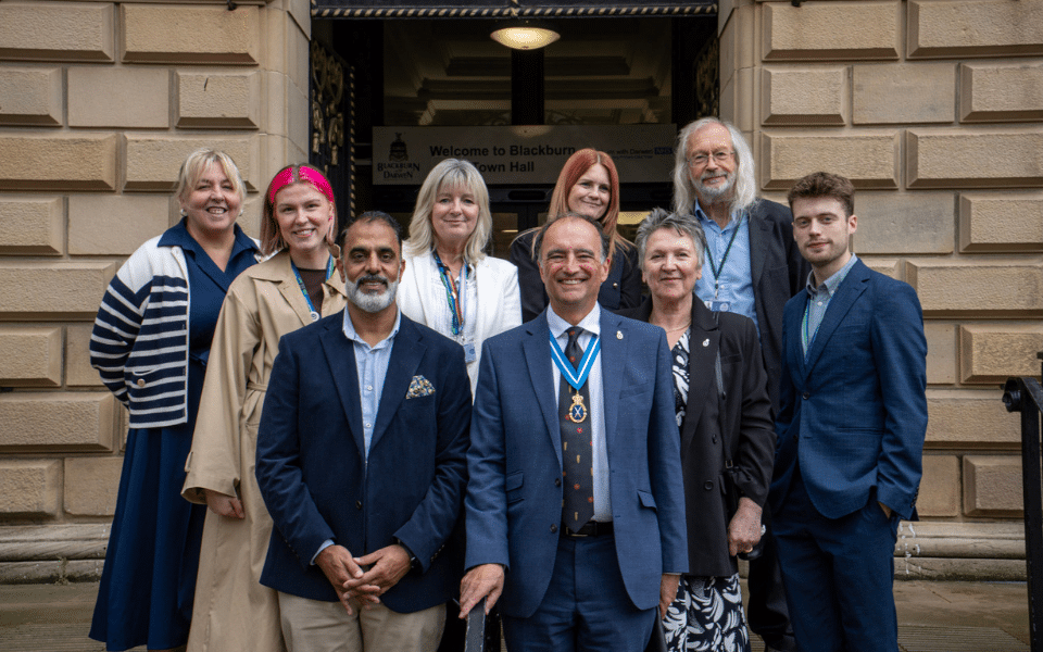 A group of people standing outside Blackburn Town Hall